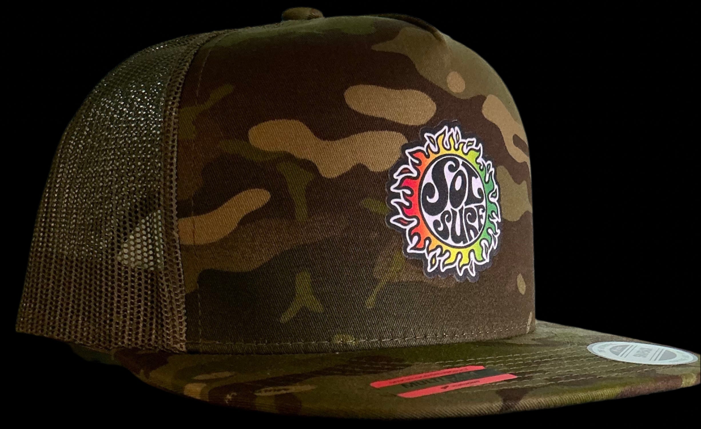 Camouflage trucker hat with colorful logo on a wooden surface